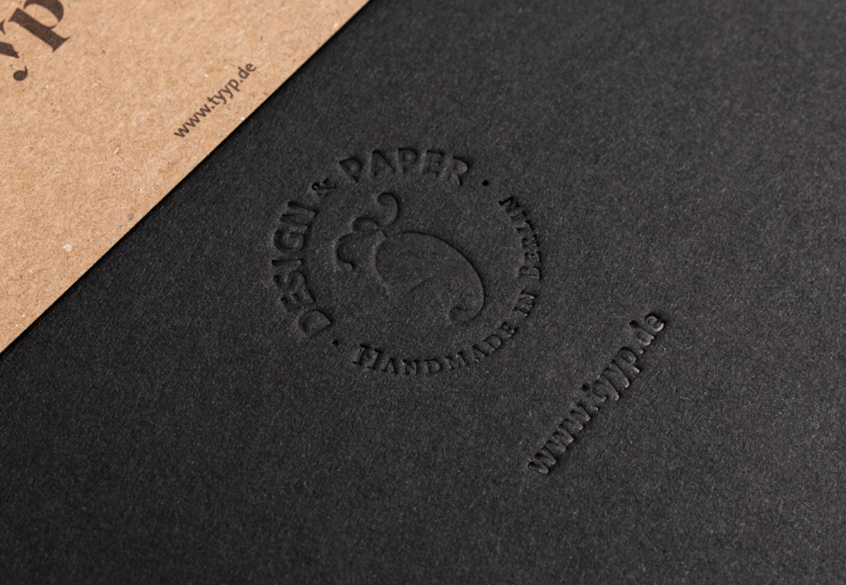 Blindprägung auf schwarzem Notizbuch Einband, Logo ohne Farbe im Material geprägt
