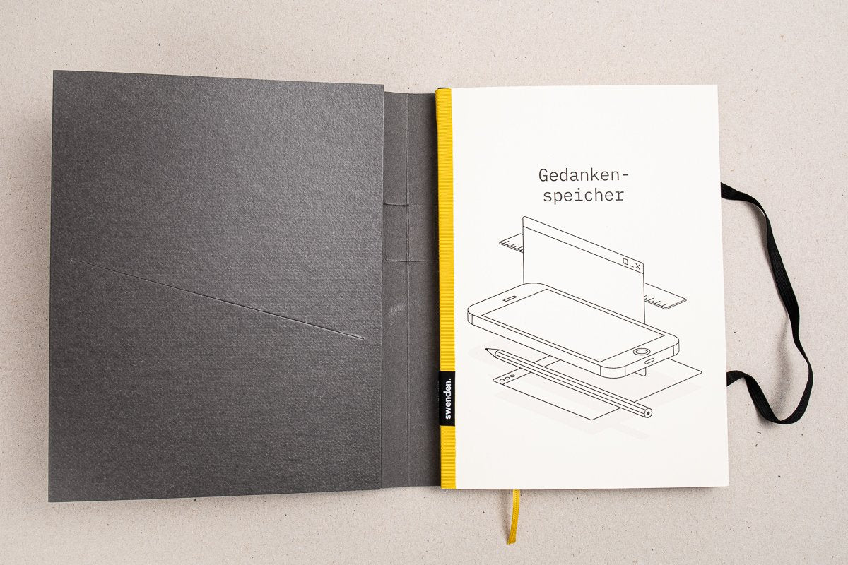 Individuelles Notizbuch mit farbigem Buchrücken und gestalteter Innenseite im Corporate Design