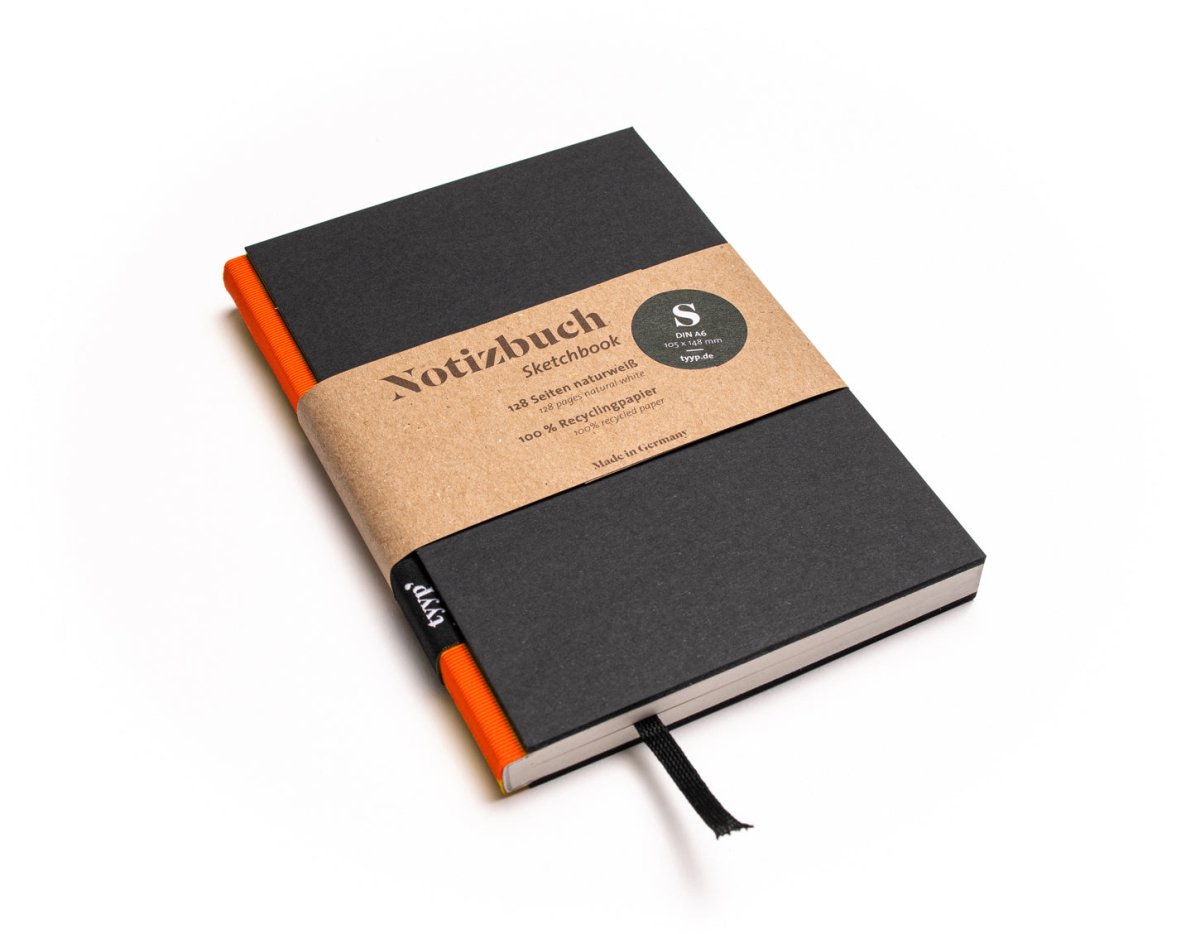 Notizbuch A6 „BerlinBook“ blanko, perforiert, Einband Schwarz | Bundfarbe Orange